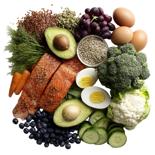 Assorted healthy foods including salmon, avocado, broccoli, and vegetables on a white background