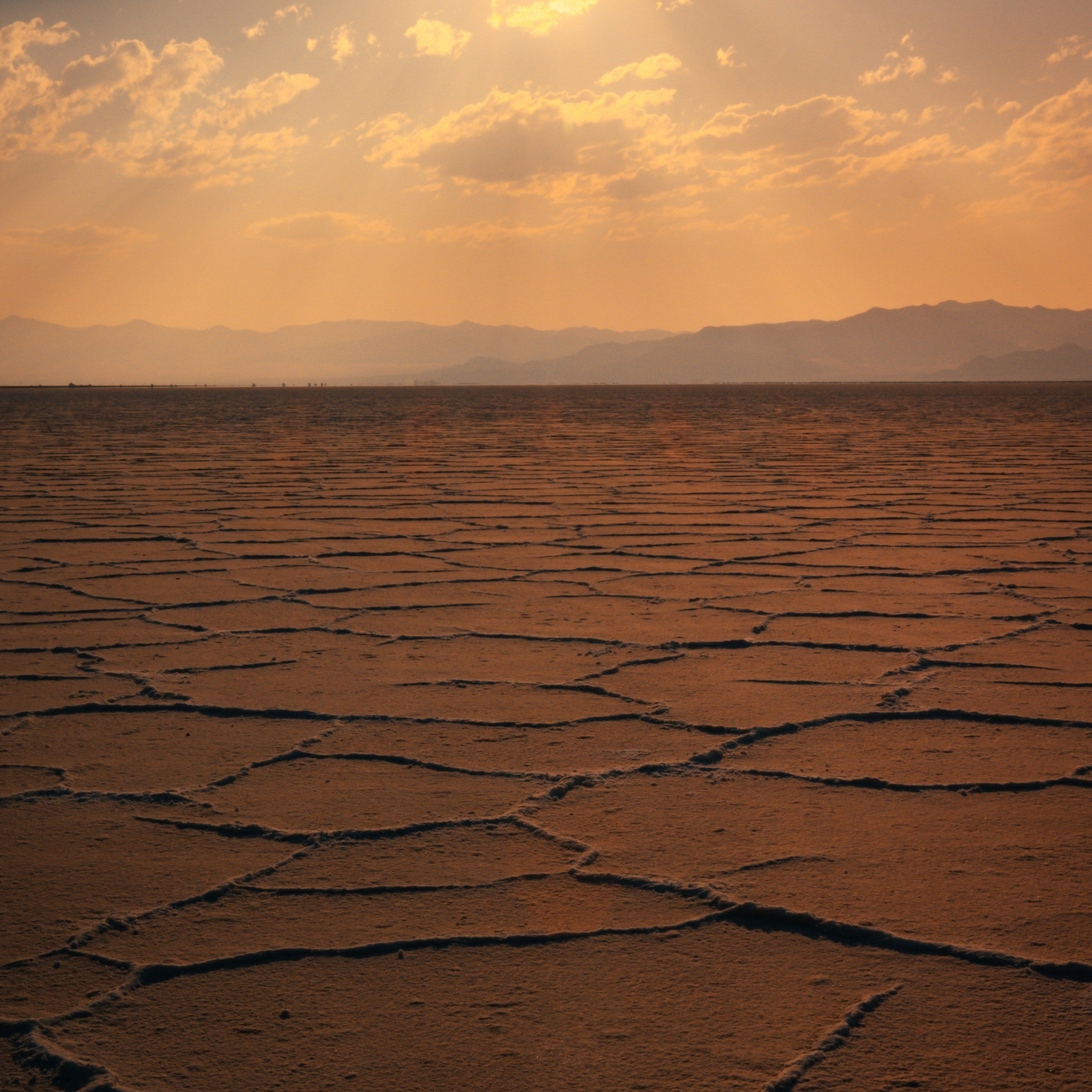 Sunset over a cracked desert landscape