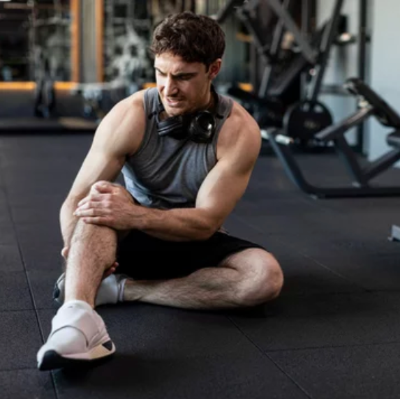 Man stretching in a gym setting