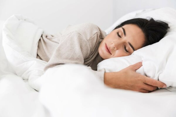 A Woman Peacefully Sleeping in Bed